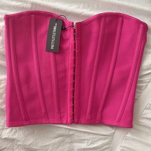 Pink corset US size small/ 4 Never worn. I ordered 2 for sizing options